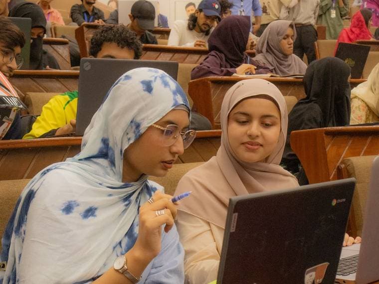 Attendees working at their laptops in the lecture hall at Session 6