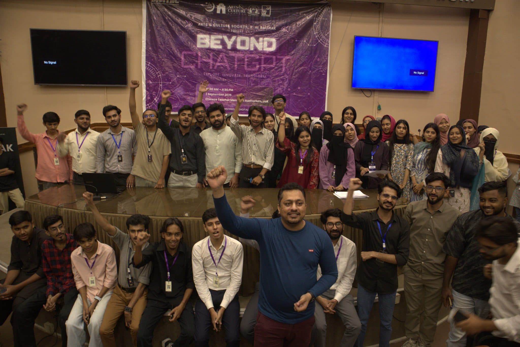 A celebration photograph of everyone at Session 6 beneath the banner